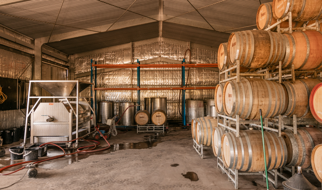 Wine making equipment and barrels in a large shed